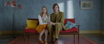 Movie still from “Mr. Nobody” (2009), directed by Jaco Van Dormael – A man and a woman sitting on a red couch; Medium shot, High angle