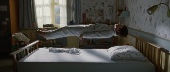 Movie still from “Mr. Nobody” (2009), directed by Jaco Van Dormael – A man is jumping in the air on a bed; Wide shot, Overhead angle