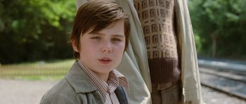 Movie still from “Mr. Nobody” (2009), directed by Jaco Van Dormael – A young boy wearing a tie and a jacket; Close Up shot, Low angle