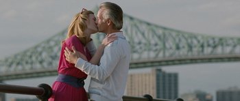 Movie still from “Mr. Nobody” (2009), directed by Jaco Van Dormael – A man and a woman kissing in front of a bridge; Medium shot, Low angle