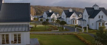 Movie still from “Mr. Nobody” (2009), directed by Jaco Van Dormael – A group of houses with a lot of trees in the background; Extreme Wide shot, High angle