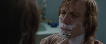 Movie still from “Mr. Nobody” (2009), directed by Jaco Van Dormael – A man shaving his face in a bathroom; Close Up shot, Over the shoulder angle