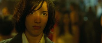 Movie still from “Mr. Nobody” (2009), directed by Jaco Van Dormael – A person's face with a blurry background; Close Up shot, Over the shoulder angle