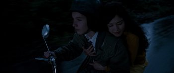 Movie still from “Mr. Nobody” (2009), directed by Jaco Van Dormael – A man and a woman riding a bike at night; Close Up shot, Overhead angle