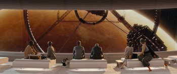 Movie still from “Mr. Nobody” (2009), directed by Jaco Van Dormael – A group of people sitting on top of a white bench; Extreme Wide shot, High angle