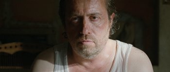 Movie still from “Mr. Nobody” (2009), directed by Jaco Van Dormael – A person wearing a white tank top; Close Up shot, Low angle