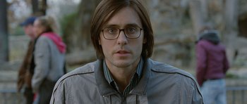 Movie still from “Mr. Nobody” (2009), directed by Jaco Van Dormael – A person wearing glasses and a jacket; Close Up shot, High angle