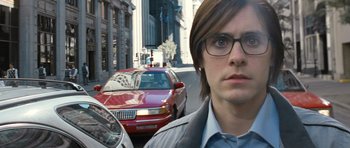 Movie still from “Mr. Nobody” (2009), directed by Jaco Van Dormael – A man with glasses standing in front of a red car; Close Up shot, High angle