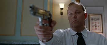 Movie still from “Mr. Nobody” (2009), directed by Jaco Van Dormael – A man in a white shirt is holding a gun; Close Up shot, Low angle