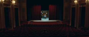 Movie still from “Mr. Nobody” (2009), directed by Jaco Van Dormael – A man sitting in a chair in a theater; Extreme Wide shot, High angle
