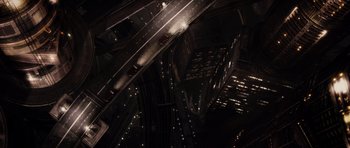 Movie still from “Mr. Nobody” (2009), directed by Jaco Van Dormael – An aerial view of a city at night with lights; Extreme Wide shot, Overhead angle