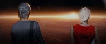 Movie still from “Mr. Nobody” (2009), directed by Jaco Van Dormael – A man and a woman standing in front of an orange sky; Medium shot, Over the shoulder angle