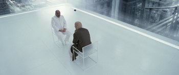 Movie still from “Mr. Nobody” (2009), directed by Jaco Van Dormael – Two men sitting on chairs in a room; Wide shot, High angle