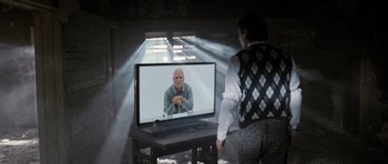 Movie still from “Mr. Nobody” (2009), directed by Jaco Van Dormael – A man is sitting in front of a television; Medium shot, Over the shoulder angle