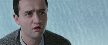 Movie still from “Mr. Nobody” (2009), directed by Jaco Van Dormael – A person wearing a suit and tie; Close Up shot, Low angle