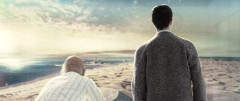 Movie still from “Mr. Nobody” (2009), directed by Jaco Van Dormael – Two men looking out at the ocean on a beach; Medium shot, Over the shoulder angle