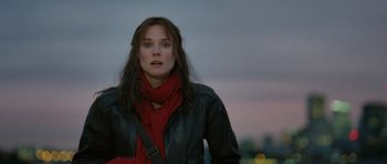 Movie still from “Mr. Nobody” (2009), directed by Jaco Van Dormael – A woman wearing a black jacket and a red scarf; Close Up shot, Over the shoulder angle