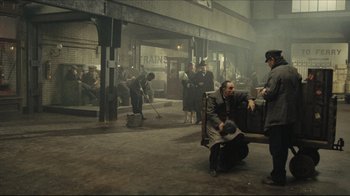 Movie still from “Once Upon a Time in America” (1984), directed by Sergio Leone – A group of men standing around a bench in an area; Wide shot, High angle