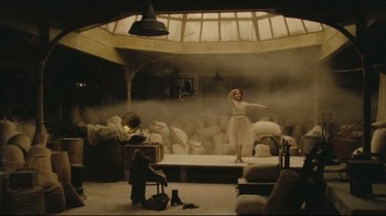 Movie still from “Once Upon a Time in America” (1984), directed by Sergio Leone – A woman in a white dress standing on a stage; Wide shot, High angle