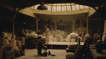 Movie still from “Once Upon a Time in America” (1984), directed by Sergio Leone – Two people in a room with a lot of bags on the floor; Wide shot, High angle