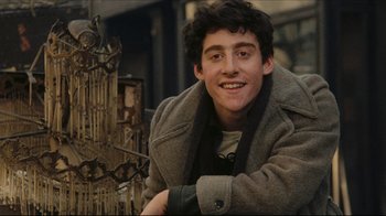 Movie still from “Once Upon a Time in America” (1984), directed by Sergio Leone – A young man in a coat smiling for the camera; Close Up shot, Over the shoulder angle
