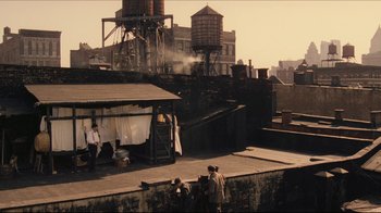 Movie still from “Once Upon a Time in America” (1984), directed by Sergio Leone – A group of people standing on top of a building next to water towers; Extreme Wide shot, High angle