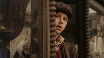 Movie still from “Once Upon a Time in America” (1984), directed by Sergio Leone – A young man wearing a hat looking out of a window; Close Up shot, Over the shoulder angle