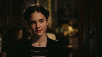 Movie still from “Once Upon a Time in America” (1984), directed by Sergio Leone – A young woman wearing a black shirt and a gold necklace; Close Up shot, Over the shoulder angle