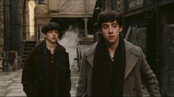 Movie still from “Once Upon a Time in America” (1984), directed by Sergio Leone – Two young men are walking down the street; Medium shot, Low angle