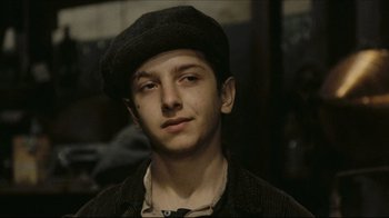 Movie still from “Once Upon a Time in America” (1984), directed by Sergio Leone – A young man wearing a black hat and a black jacket; Close Up shot, Over the shoulder angle