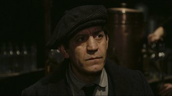 Movie still from “Once Upon a Time in America” (1984), directed by Sergio Leone – A person wearing a hat and a suit; Close Up shot, High angle