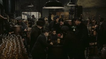 Movie still from “Once Upon a Time in America” (1984), directed by Sergio Leone – A group of people standing around a table; Wide shot, High angle