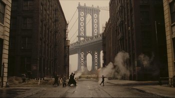 Movie still from “Once Upon a Time in America” (1984), directed by Sergio Leone – A group of people standing on the side of a street; Extreme Wide shot, High angle