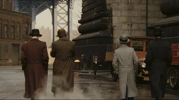 Movie still from “Once Upon a Time in America” (1984), directed by Sergio Leone – A group of men standing next to each other on a street; Extreme Wide shot, High angle