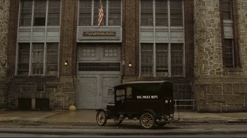 Movie still from “Once Upon a Time in America” (1984), directed by Sergio Leone – An old truck is parked in front of a building; Extreme Wide shot, Low angle