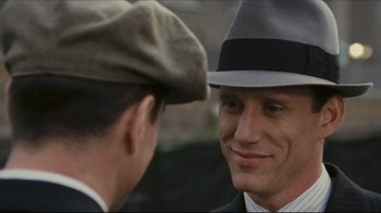 Movie still from “Once Upon a Time in America” (1984), directed by Sergio Leone – A man in a suit and hat talking to another man in a hat; Close Up shot, Over the shoulder angle