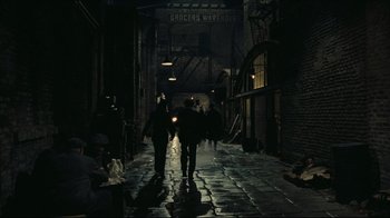 Movie still from “Once Upon a Time in America” (1984), directed by Sergio Leone – A couple of people walking down a street at night; Wide shot, High angle