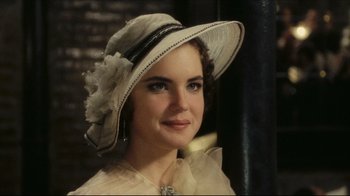 Movie still from “Once Upon a Time in America” (1984), directed by Sergio Leone – A woman wearing a white hat with a flower on it; Close Up shot, Over the shoulder angle