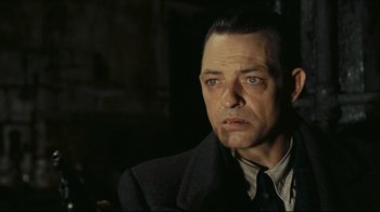 Movie still from “Once Upon a Time in America” (1984), directed by Sergio Leone – A person wearing a suit and tie; Close Up shot, Over the shoulder angle