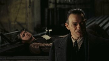 Movie still from “Once Upon a Time in America” (1984), directed by Sergio Leone – A man in a suit and tie standing next to a woman in a suit; Medium shot, Over the shoulder angle