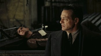 Movie still from “Once Upon a Time in America” (1984), directed by Sergio Leone – A man standing next to another man laying on the ground; Medium shot, Over the shoulder angle