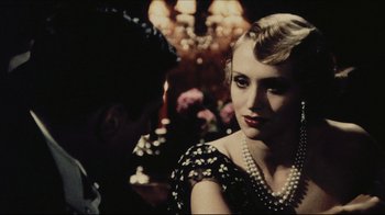 Movie still from “Once Upon a Time in America” (1984), directed by Sergio Leone – A woman in a black and white polka dot dress with pearls; Close Up shot, Over the shoulder angle