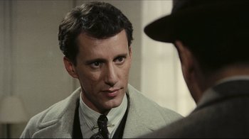 Movie still from “Once Upon a Time in America” (1984), directed by Sergio Leone – A person wearing a suit and a tie; Close Up shot, Over the shoulder angle
