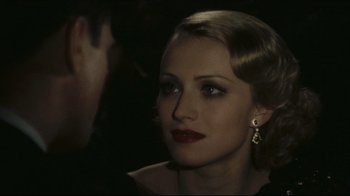 Movie still from “Once Upon a Time in America” (1984), directed by Sergio Leone – A beautiful woman with red lipstick looking at the camera; Close Up shot, Over the shoulder angle