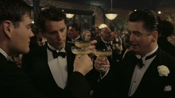 Movie still from “Once Upon a Time in America” (1984), directed by Sergio Leone – Two men in tuxedos holding glasses of champagne; Medium shot, High angle