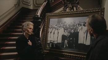 Movie still from “Once Upon a Time in America” (1984), directed by Sergio Leone – An older woman standing in front of an old picture; Medium shot, High angle