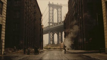 Movie still from “Once Upon a Time in America” (1984), directed by Sergio Leone – A view of a bridge in the distance from a city street; Extreme Wide shot, Low angle