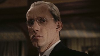 Movie still from “Once Upon a Time in America” (1984), directed by Sergio Leone – An older man wearing glasses and a suit; Close Up shot, Low angle