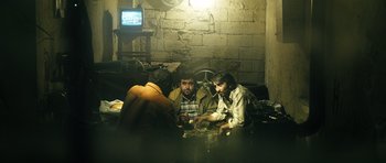Movie still from “Once Upon a Time in Anatolia” (2011), directed by Nuri Bilge Ceylan – A group of people sitting around a table; Wide shot, High angle