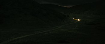 Movie still from “Once Upon a Time in Anatolia” (2011), directed by Nuri Bilge Ceylan – A car driving down a road in the middle of the night; Extreme Wide shot, High angle